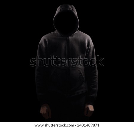 Silhouette of man in the hood or hooligan over dark background with copy space,