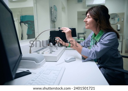Radiologic technologist communicating with patient during x-ray examination Royalty-Free Stock Photo #2401501721