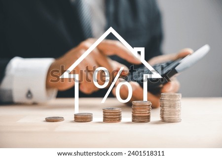 Pressing calculators, hand plans house refinance. Buy or rent, wooden house model on desk. Save for buying home concept, mortgage payment strategy. Tax, credit analysis for wise investment decision. Royalty-Free Stock Photo #2401518311