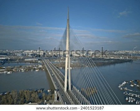 Bridge with pylon, city and river aerial view 