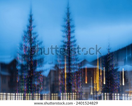 abstract colorful design of christmas lights blurred and out of focus showing movement created by in camera movement and long or slow shutter speed 