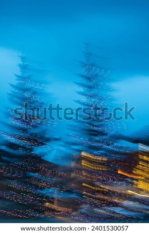vertical abstract design of christmas tree lights outdoor lights abstract design motion blur created by intentional camera movement long shutter speed