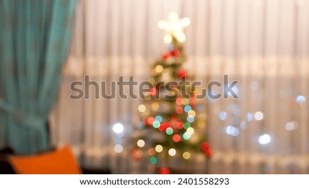 Defocused , blurred lighted Christmas tree in a living room                              