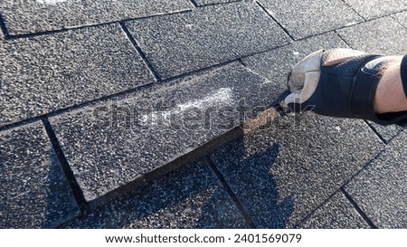 Residential roof inspection for an insurance claim due to storm damage.  Royalty-Free Stock Photo #2401569079