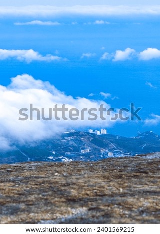 view from a high mountain clouds hanging over the city