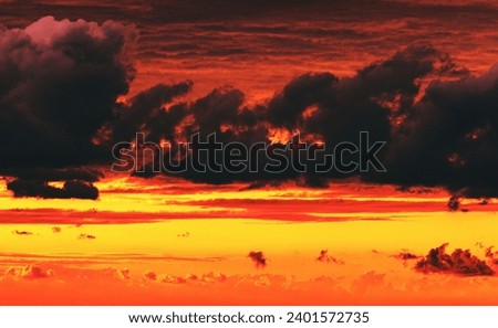 dramatic cloudy sky at fiery sunset  Royalty-Free Stock Photo #2401572735