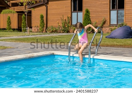 Cute little girl in swimming pool on sunny day. Space for text