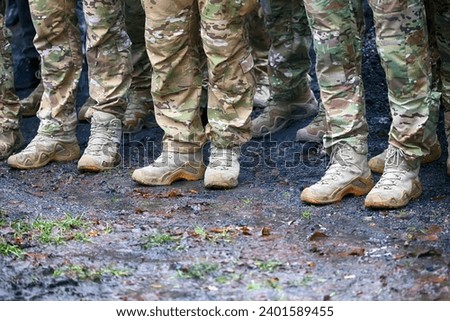 Special forces soldiers stand in a row. Royalty-Free Stock Photo #2401589455