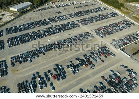 Used damaged cars on auction reseller company big parking lot ready for resale services. Sales of secondhand vehicles for rebuilt or salvage title Royalty-Free Stock Photo #2401591459