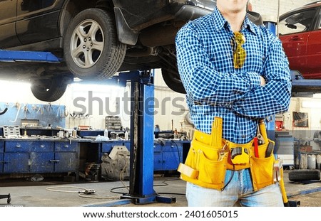 Car Mechanic in Car Repairing garage and Car repairing shop Stock image. Car mechanic with holding tools background hd stock image.