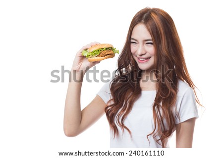 Young woman eating hamburger on white background