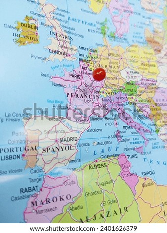 Push red pin or red tack  on the territory of France or Perancis on the world map. Close up zoom image of Vertical image. 