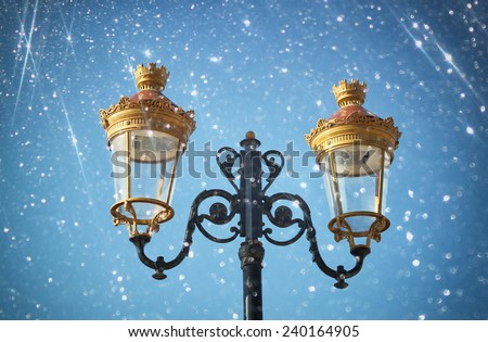 Picture of an antique street lamp against blue sky. vintage filtered image and bokeh lights.
