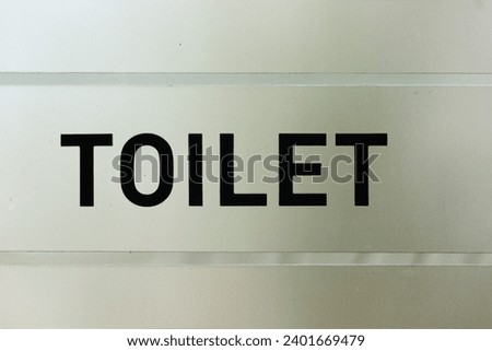 Toilet sign word sticker sticky on the glass of door
