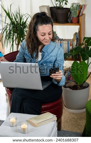 Banking Connection: Photograph of a Woman Sitting with her Computer and Bank Card, Smiling in the Age of Financial Technology, Space for Copy