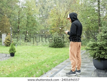 Young Man playing with drone outdoors