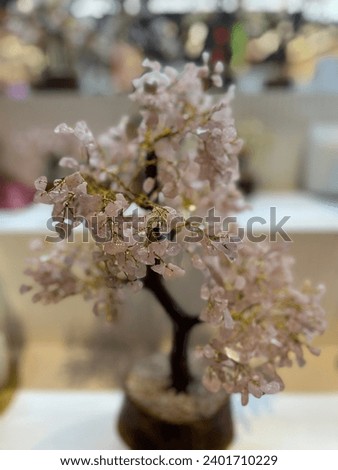 Rose quartz gemstone tree pictured individually. 
