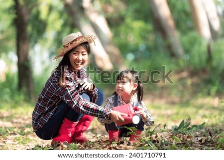 Asia family mother and kid daughter plant sapling tree outdoors in nature spring for reduce global warming growth feature and take care nature earth
