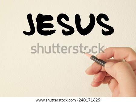 Jesus hand writing with a black mark on wall 