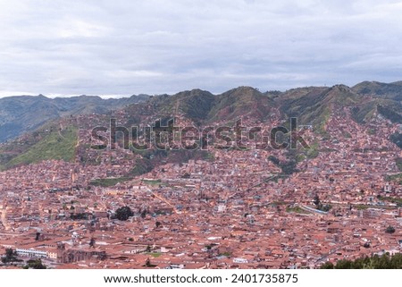 Panorama of Cusco, Cuzco, Peru by night, with the Andes Mountains in the background.. Morning picture with a beautiful light and sky..
