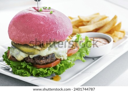 beetroot red bun cheese burger snack set with fries and chilli mayo on white plate