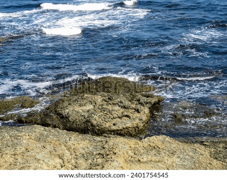 Sea with waves and rocks on the shore Royalty-Free Stock Photo #2401754545