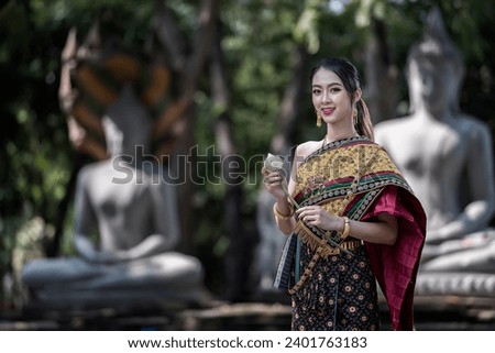  women in traditional clothing  on Buddhist on background.  Portrait women in traditional clothing , Thai traditional  in Ayutthaya, Thailand. Royalty-Free Stock Photo #2401763183