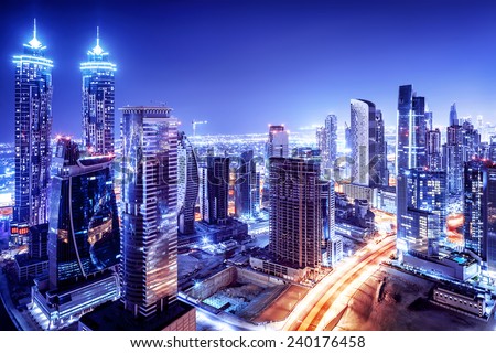 Dubai downtown night scene, UAE, beautiful modern buildings, bright glowing lights, luxurious travel and tourism  Royalty-Free Stock Photo #240176458
