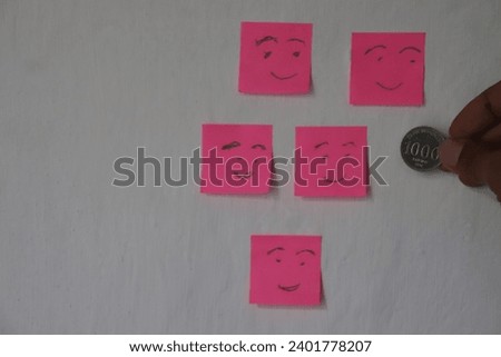 Emotion smile on pink paper. Paper smile symbol with pink background color. borrow one hundred rupiah first