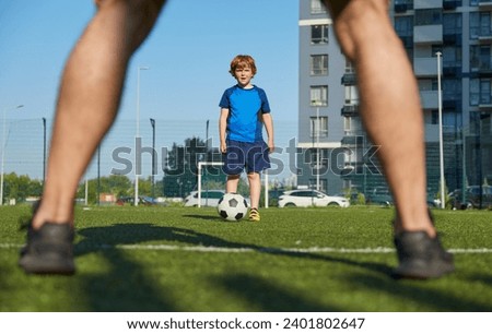 Father and son playing family football summer camp at city stadium Royalty-Free Stock Photo #2401802647