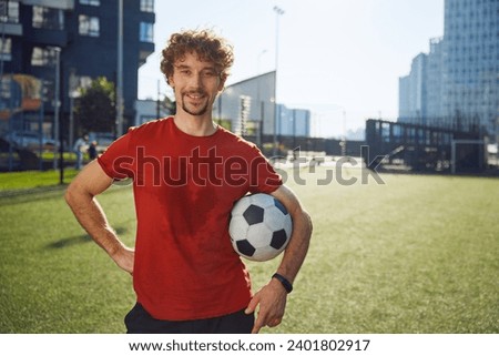 Portrait of happy male football trainer or soccer player with sweaty face Royalty-Free Stock Photo #2401802917