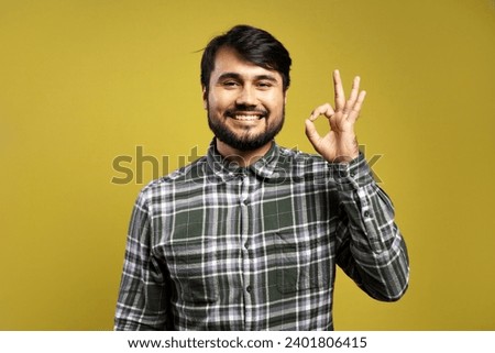 smiling man making OK sign with his hand
