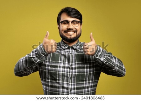 man smiling and giving thumbs up with both hands