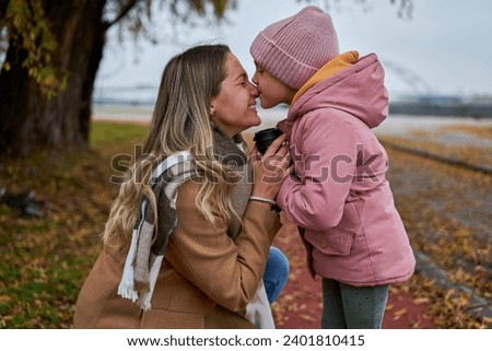 In candid pauses, the mother and daughter share hugs and kisses, creating cherished memories amid their walk.                          