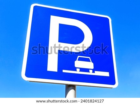 Angle view on parking sign for cars against a blue sky background