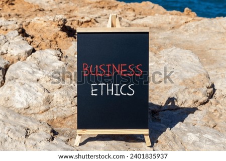 Business ethics symbol. Concept words Business ethics on beautiful black chalk blackboard. Beautiful stone beach blue sea sky background. Business ethics concept. Copy space.
