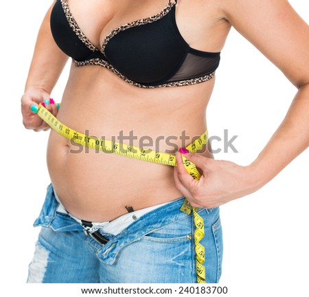 Overweight woman measuring waistline with centimeter on a white background