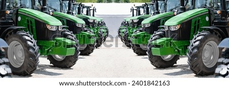 A row of green agricultural tractors.