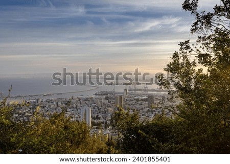 Beautiful panoramic view from Mount Carmel (Louis Promenade) beautiful dramatic marmalade sky  cityscape and port in Haifa, Israel. Royalty-Free Stock Photo #2401855401