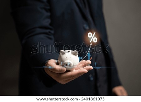 Man hold the piggy bank and virtual graph stock on his hand. Save money for the future. Finance investment wealth for family. Planning growth money and earn interest from bank.