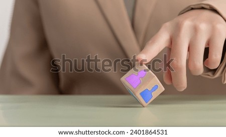 The image of choosing people to work The HR manager is selecting the right employees for the position ,Businessman uses finger to touch people icon ,wooden block with people icon.