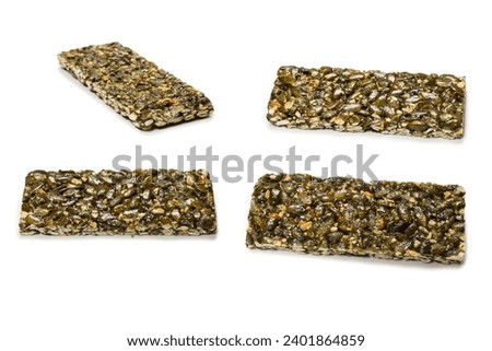Bar with nuts isolated on a white background. Pumpkin seeds bar. Top view. 