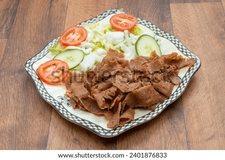 Doner Kebabs on plates, in pitta bread, with salad, with chips, munchy boxes, doner wrap  Royalty-Free Stock Photo #2401876833