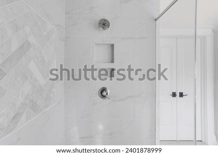 Modern Bathroom Shower Niche with Elegant White Marble Tiles and Chrome Fixtures in Contemporary Home Interior Design Royalty-Free Stock Photo #2401878999