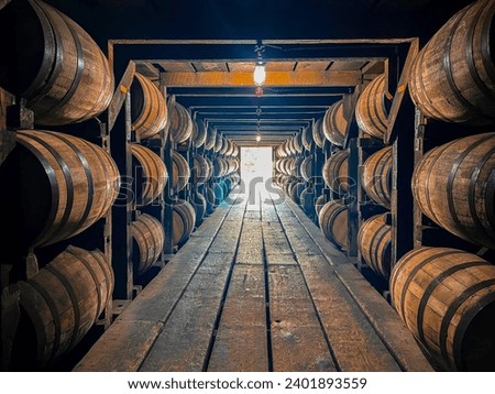 Bourbon barrels aging in rickhouse Royalty-Free Stock Photo #2401893559