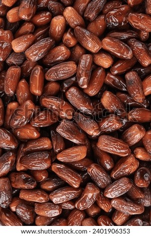 Full Frame Background Top View of Pile of Appetizing Honey Dried Date Kurma Tunisian Fruits Arranged on Table  Royalty-Free Stock Photo #2401906353
