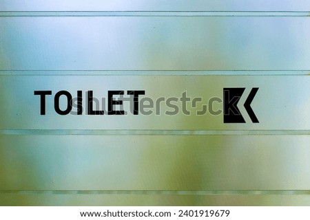 Toilets icon, Public restroom signs ,sticker toilet sign and direction on glass door blurred background.
