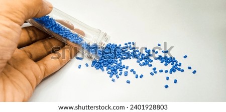 Hand poured blue polymer masterbatch granules isolated on a white background for the design of a product profile photo for an industrial plastics company catalogue