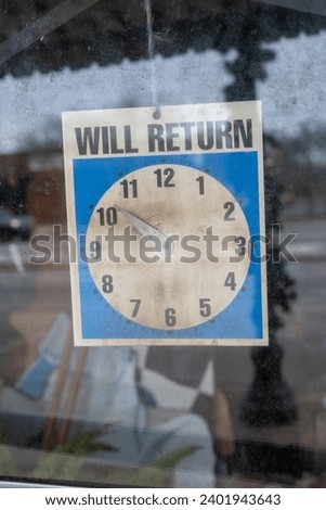 A vintage storefront window with a prominent "Will Return" sign, its clock set to 10:51, capturing a moment frozen in time and resonating with a sense of bygone eras and urban charm.
