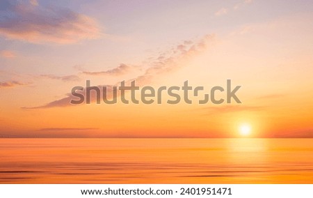 Beautiful majestic golden sunrise sky with yellow sunlight and motion blur of flowing sea surface in the morning